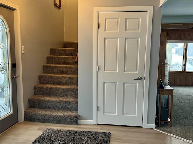 staircase with baseboards and wood finished floors
