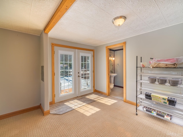 doorway with light carpet, french doors, and baseboards