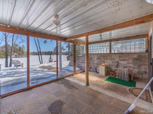 unfurnished sunroom with a water view