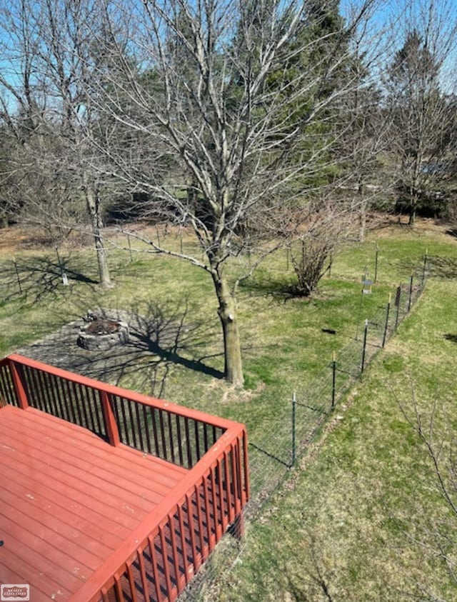 view of yard with an outdoor fire pit, fence, and a deck