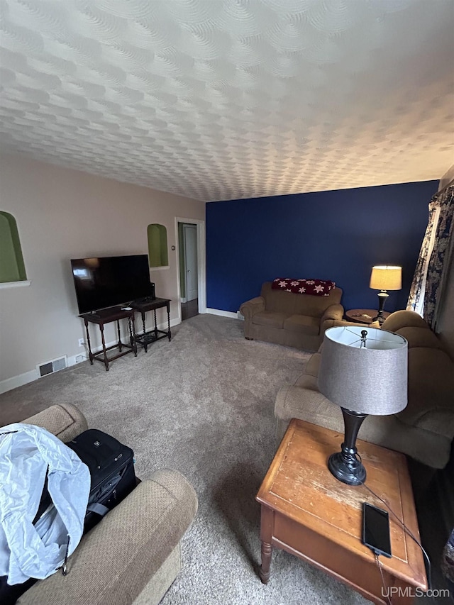 living area with carpet flooring, baseboards, and visible vents