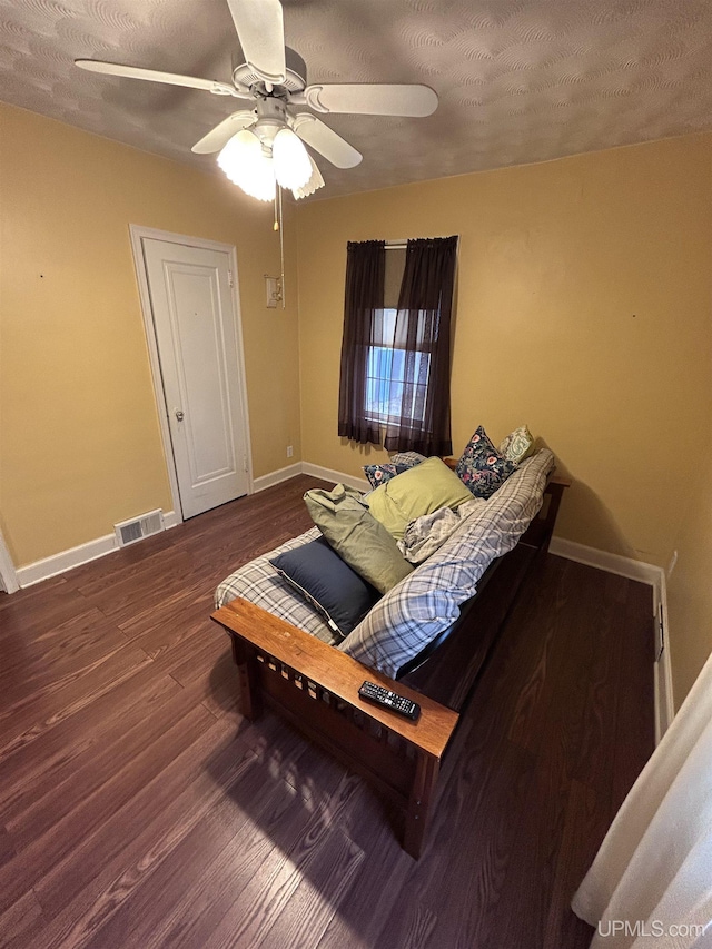 living room with visible vents, baseboards, ceiling fan, and wood finished floors