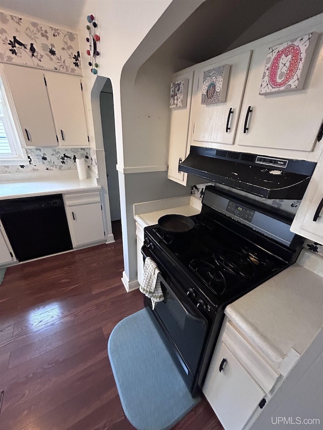 kitchen featuring dark wood-style flooring, light countertops, white cabinets, arched walkways, and black appliances