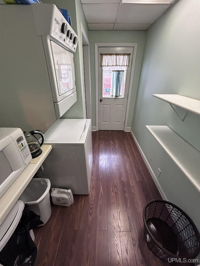 interior space with dark wood-style flooring, baseboards, and laundry area