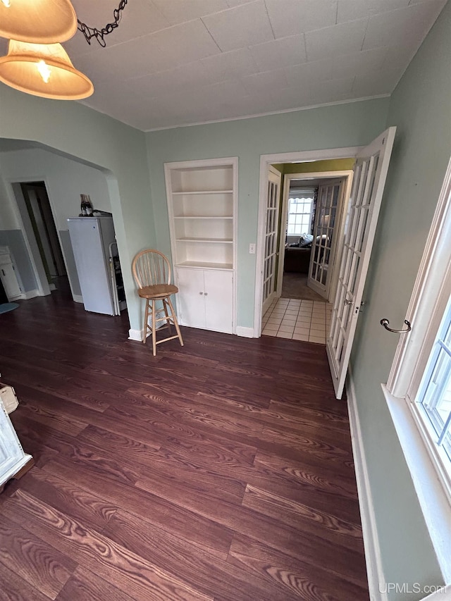 interior space featuring plenty of natural light, built in features, and wood finished floors