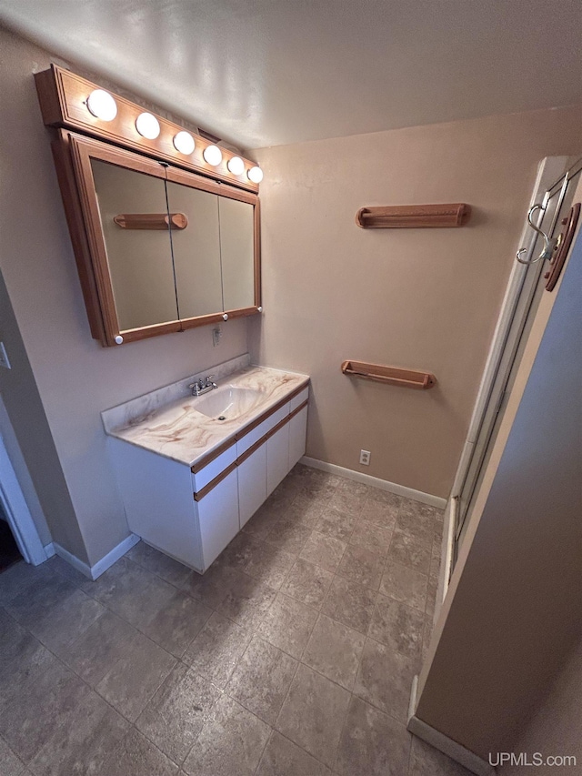full bathroom with vanity and baseboards