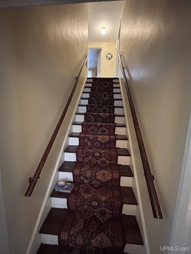 stairway featuring baseboards