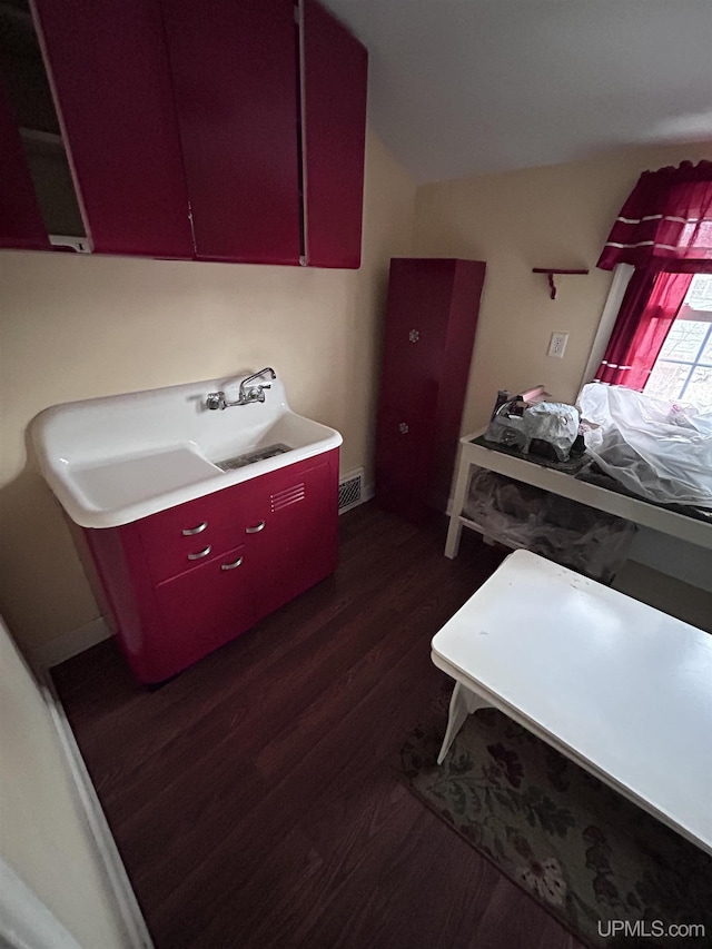 laundry area featuring dark wood-type flooring and visible vents