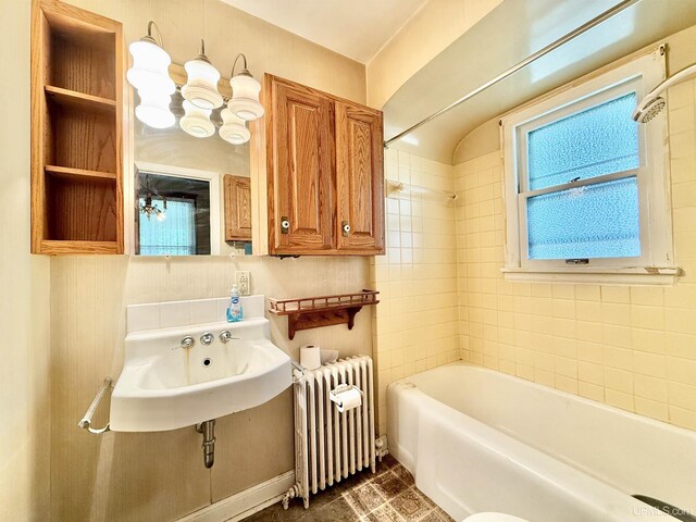 404 Lake Shore Dr, Escanaba, MI 49829 - full bath featuring radiator heating unit, a sink, and shower / tub combination