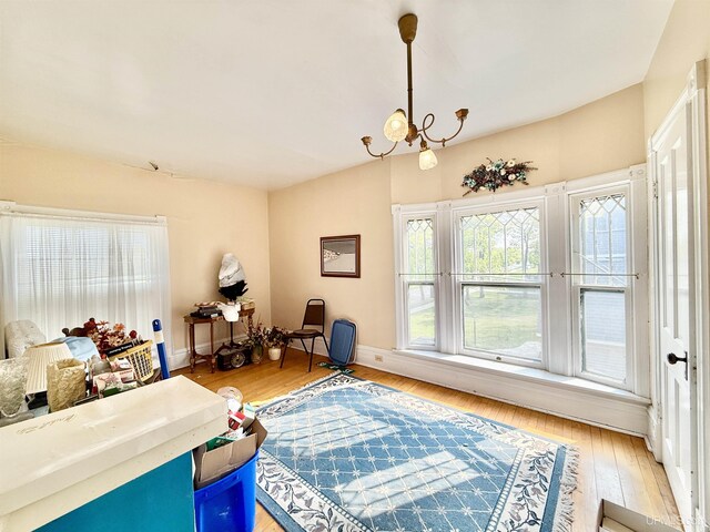 404 Lake Shore Dr, Escanaba, MI 49829 - living area featuring light wood-style floors, baseboards, and a chandelier