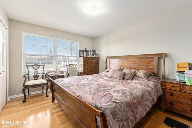 bedroom featuring a closet, baseboards, and hardwood / wood-style floors