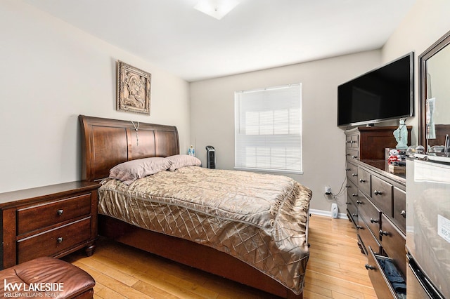 bedroom featuring light wood-style flooring and baseboards