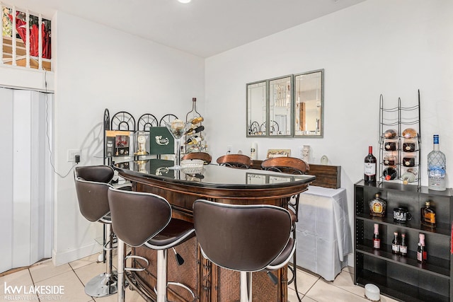 bar with indoor bar and light tile patterned floors