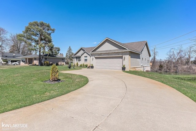 view of front of home with concrete driveway, a front yard, brick siding, and a garage