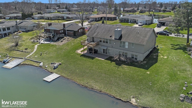 birds eye view of property featuring a water view and a residential view