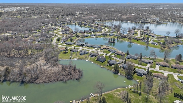 birds eye view of property with a water view and a residential view