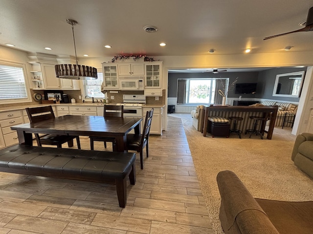 dining space featuring light wood-style floors, recessed lighting, and visible vents