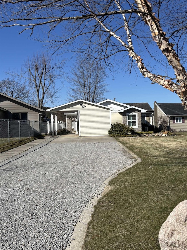 view of home's exterior featuring a yard, driveway, and fence