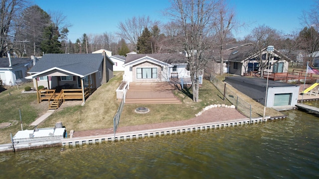 rear view of property featuring a fenced backyard, stairs, a deck with water view, and a lawn