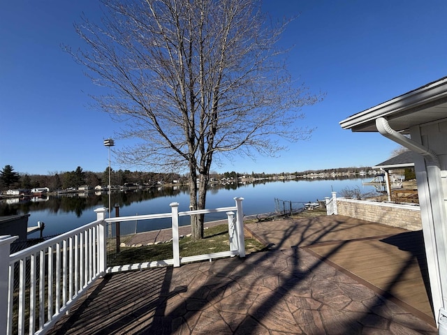 wooden deck with a boat dock and a water view