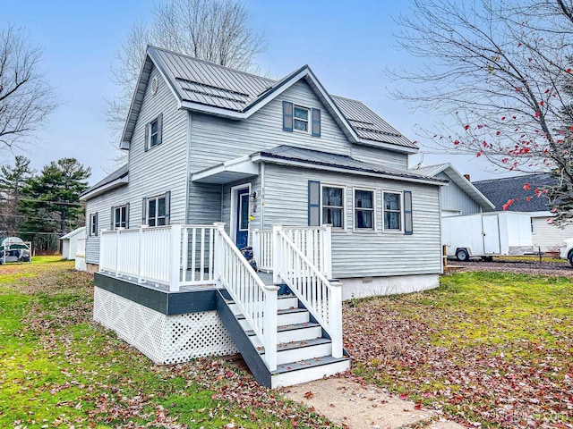 104 Birch St, Bergland, MI 49910 - traditional-style home featuring metal roof and a deck