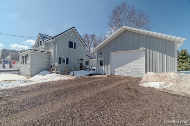 104 Birch St, Bergland, MI 49910 - view of home's exterior featuring a detached garage, an outdoor structure, and dirt driveway