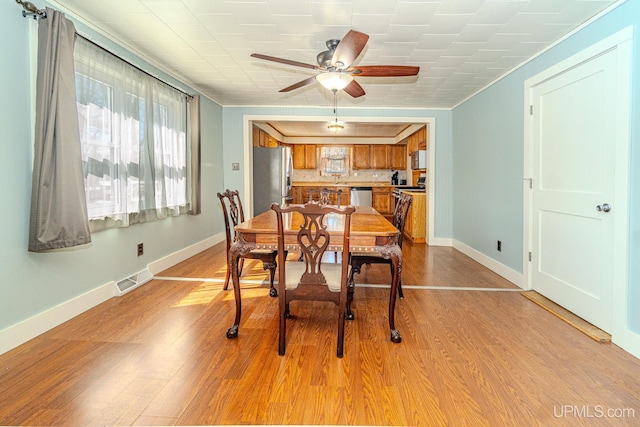 104 Birch St, Bergland, MI 49910 - dining room with light wood-style flooring, baseboards, visible vents, and ceiling fan