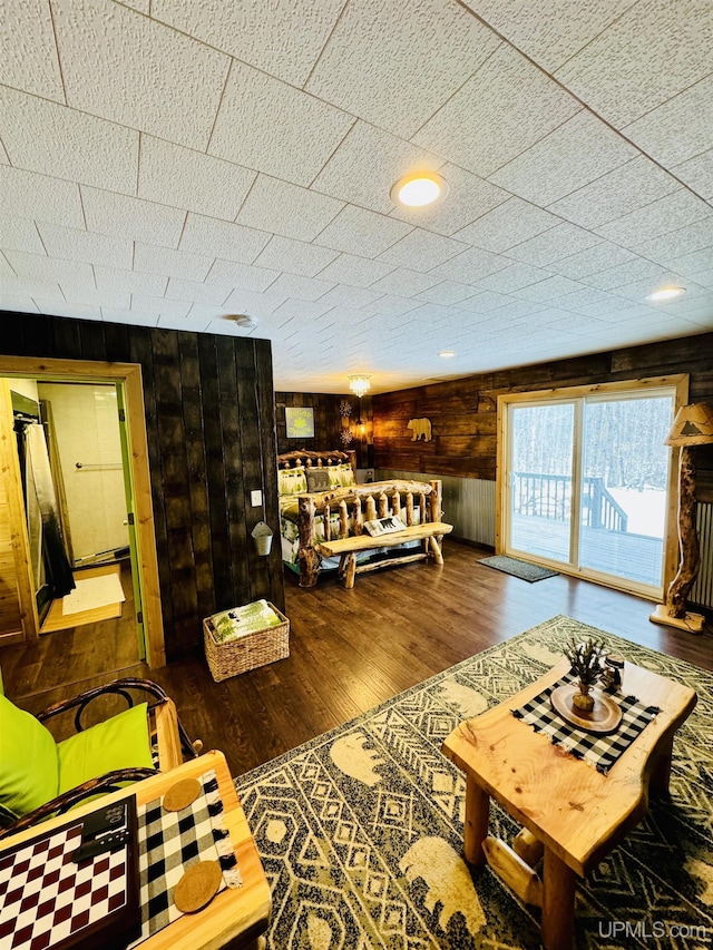 living room with wood walls and wood finished floors