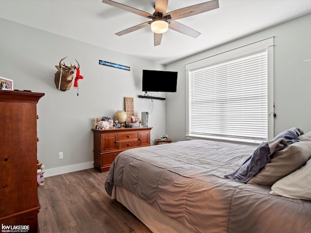 bedroom with dark wood-style flooring, baseboards, and ceiling fan