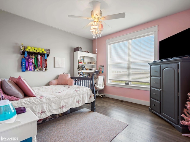 bedroom featuring baseboards, ceiling fan, and wood finished floors