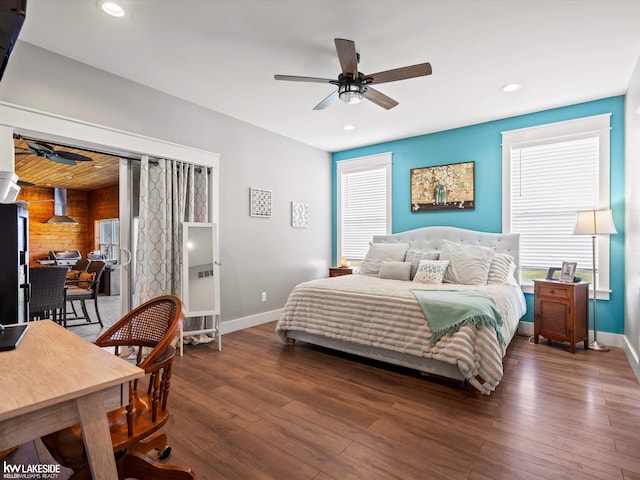 bedroom featuring dark wood-style flooring, multiple windows, and baseboards