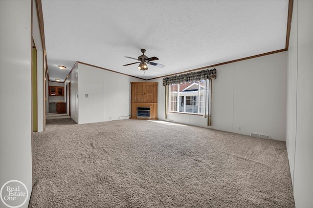 6240 Twin Lakes Dr, Kimball, MI 48074 - unfurnished living room with visible vents, carpet floors, crown molding, and ceiling fan
