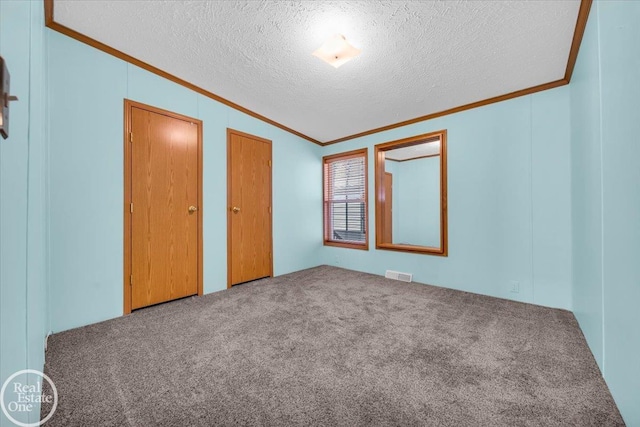 6240 Twin Lakes Dr, Kimball, MI 48074 - unfurnished bedroom featuring visible vents, a textured ceiling, ornamental molding, and carpet floors