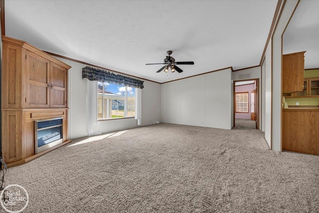 6240 Twin Lakes Dr, Kimball, MI 48074 - unfurnished living room featuring a ceiling fan, visible vents, ornamental molding, a glass covered fireplace, and carpet floors