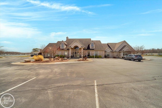 6240 Twin Lakes Dr, Kimball, MI 48074 - french country home featuring stone siding and uncovered parking