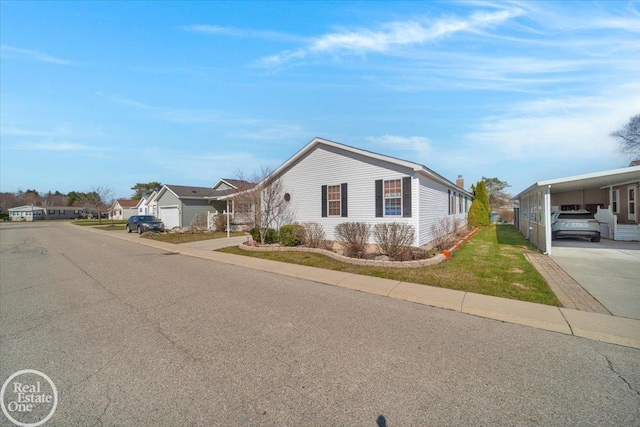 6240 Twin Lakes Dr, Kimball, MI 48074 - view of front of home with a carport and a front lawn