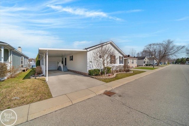 6240 Twin Lakes Dr, Kimball, MI 48074 - view of front of property with concrete driveway, a front yard, and an attached carport