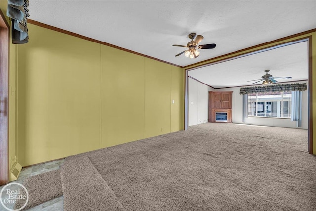 6240 Twin Lakes Dr, Kimball, MI 48074 - unfurnished living room featuring a glass covered fireplace, carpet floors, a textured ceiling, and ceiling fan
