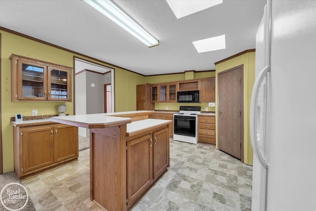 6240 Twin Lakes Dr, Kimball, MI 48074 - kitchen featuring crown molding, light countertops, white appliances, and a skylight