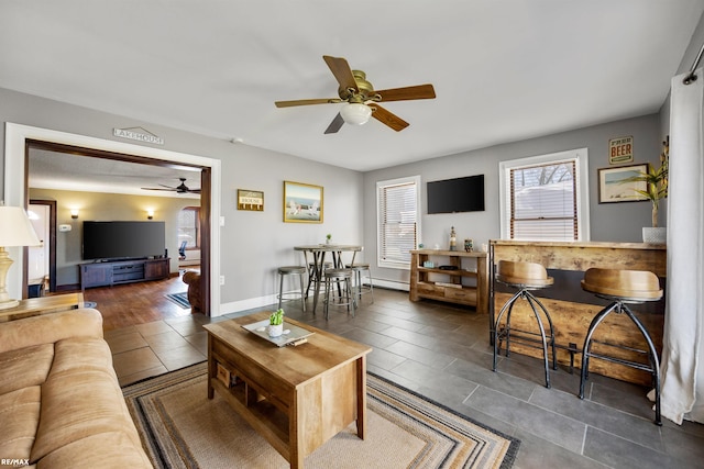 living room with ceiling fan and tile patterned flooring