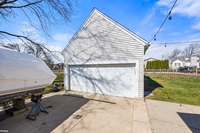 detached garage featuring fence