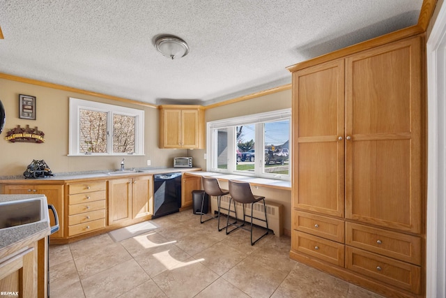 kitchen with built in desk, a textured ceiling, crown molding, black dishwasher, and a sink
