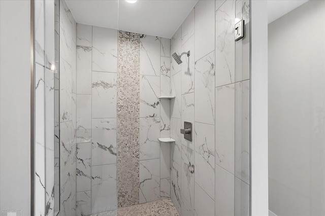 full bath with a tile shower