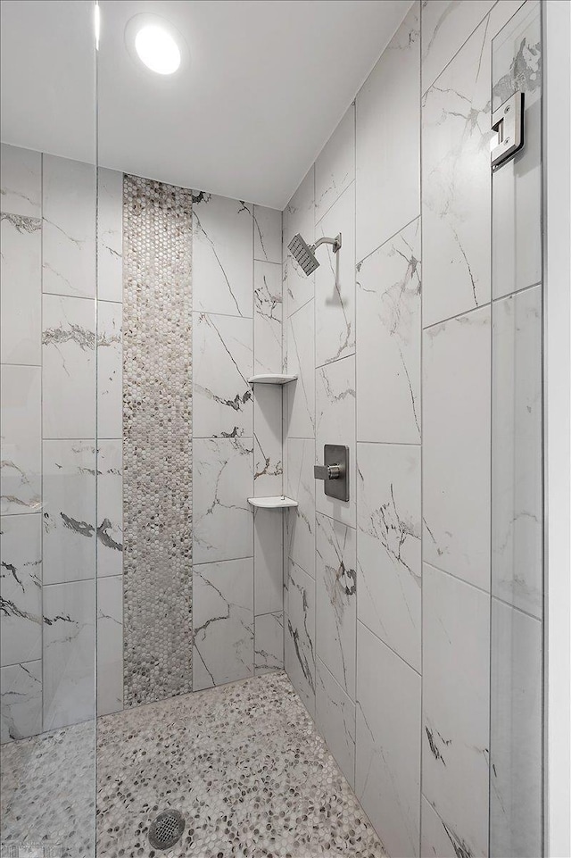 full bath with a tile shower