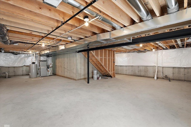 unfinished basement with water heater and heating unit