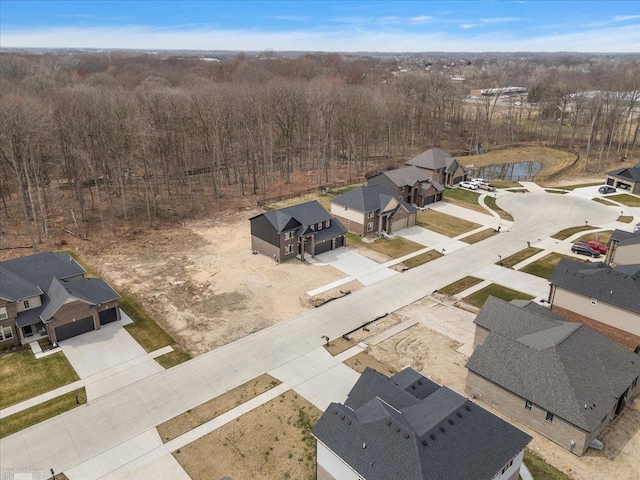 birds eye view of property featuring a water view and a residential view