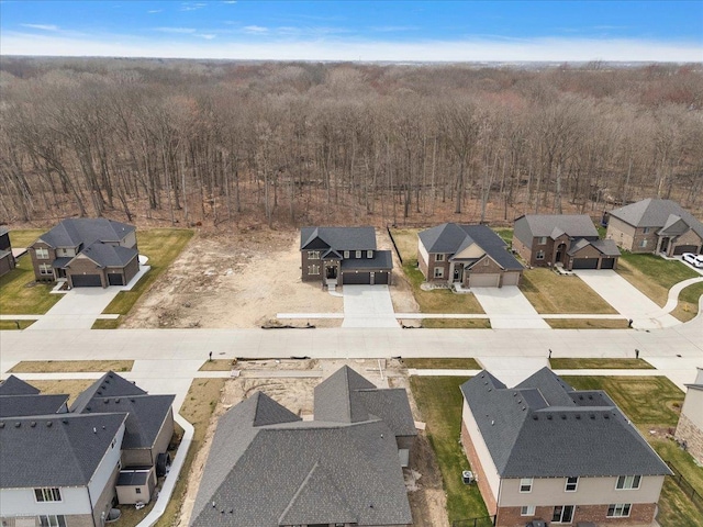 aerial view featuring a wooded view and a residential view