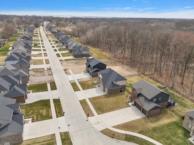 bird's eye view featuring a view of trees and a residential view