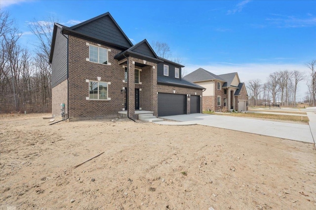 traditional-style home featuring concrete driveway, brick siding, and an attached garage