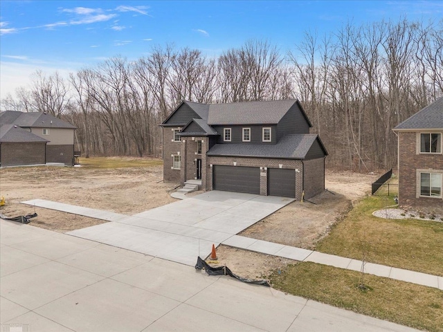 view of front of property with concrete driveway, a front yard, brick siding, a garage, and a shingled roof